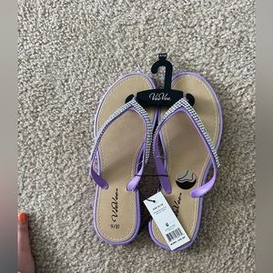 Purple flip-flops never worn